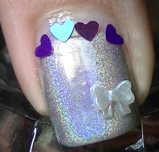 Add some holo hearts over the half moon and repeat this design for the accent nail