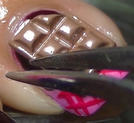 Apply a 3D nail art chocolate bar on the middle and thumb fingers