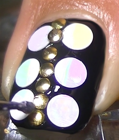 Apply studs all over the center of the nail in a vertical line.