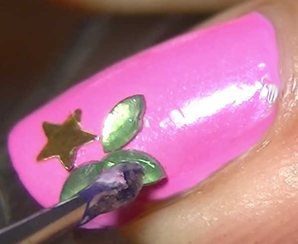 Index nail: Paint pink then add a sequin star and water drop rhinestones. Repeat this step for the pinky nail but paint it yellow instead of pink.