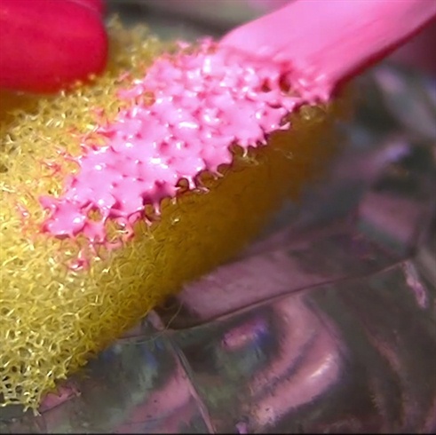 Add pink nail polish to a sponge.