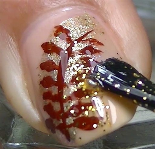 Apply a coat of golden glitter nail polish