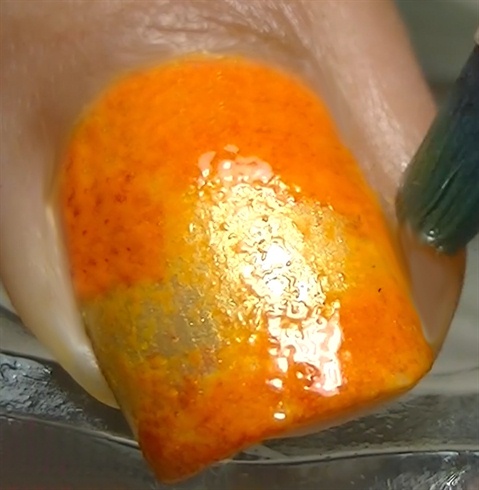 Repeat the process but use a neon orange nail polish and clean the sides of the nail with nail polish remover.