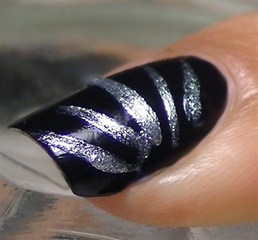 Paint the rest of your nails black and create 5 silver lines as shown