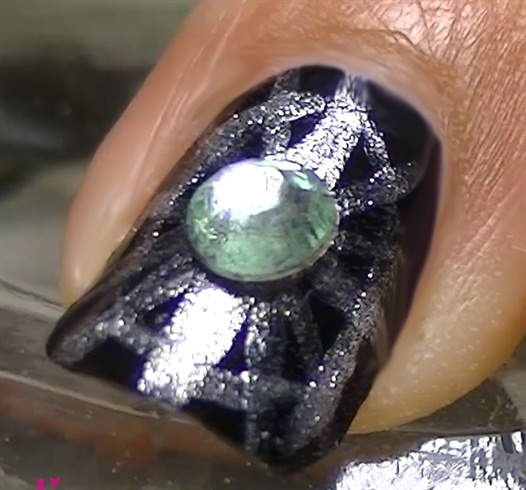 Add a rhinestone on the middle finger's nail
