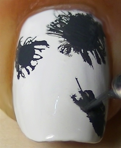 Draw the splatter effect with a nail art brush.