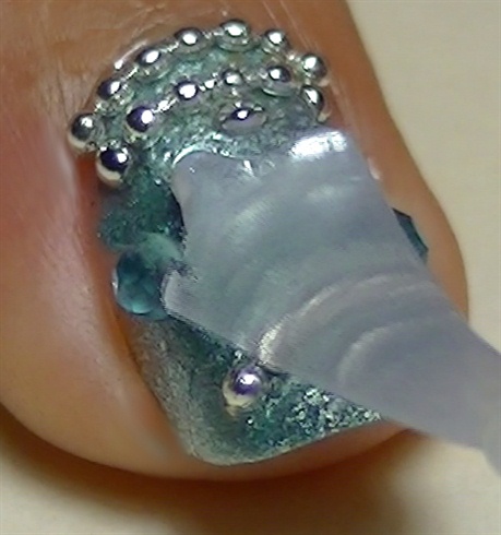 Apply top coat to protect and seal your nail art design
