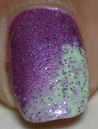 Apply a layer of a silver glitter nail polish to blend the colors in.