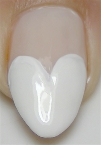 Using a white nail polish create a heart tip french manicure
