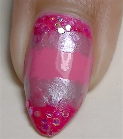 Add fine glitter over the pink glitter nail polish