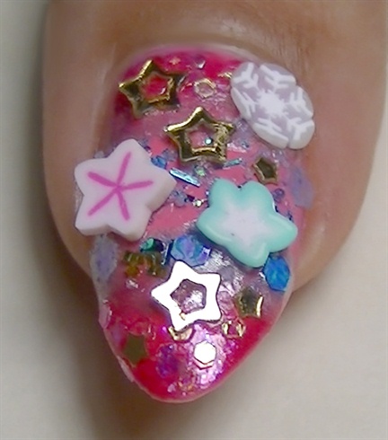 Add some golden stars using clear polish to act as glue