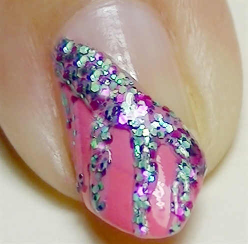 Using a glitter liner nail polish, create stripes as shown