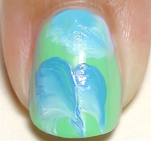 For the rest of the nails, paint using the one stroke technique with white and light blue paints
