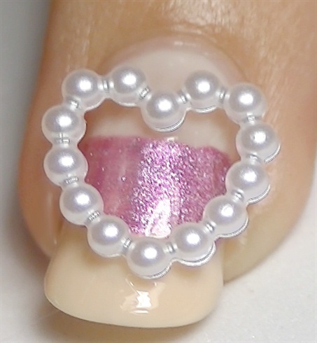 Apply nail glue and place a 3D pearl heart