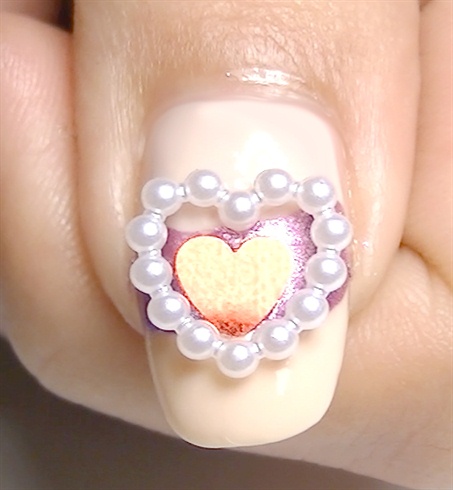 Add a little top coat in the middle and place a red heart