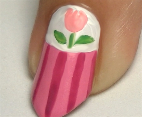 Over the accent and thumb nails, draw a cute tulip flower using acrylic paints