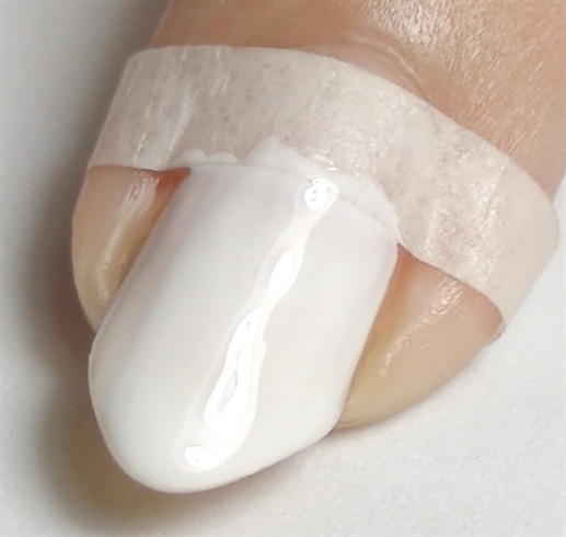 Start with the base coat to protect your natural nails, place tape and paint your nails white