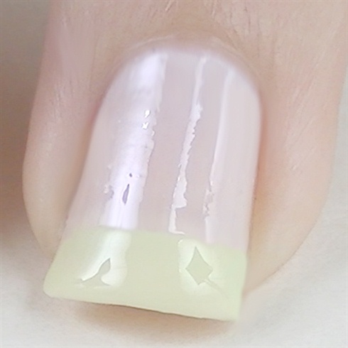 Apply base coat to protect your natural nails then paint your nails with a nude or white base. Create a french manicure using a mint nail polish.