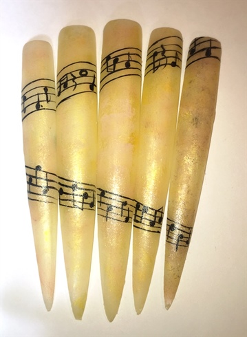 I started by painting my nail tips with a soft ivory nail polish from Julep.  I sponged on some acrylic paint in gold & peach tones, and hand-painted the music staff.