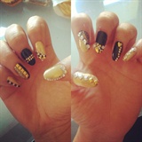 Studded nail art on gold and black