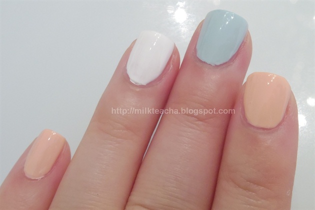 First, apply base coat to all your nails. Then, apply nude peach polish index finger and pinky. Apply mint polish on the middle finger. Apply white polish to the ring finger.
