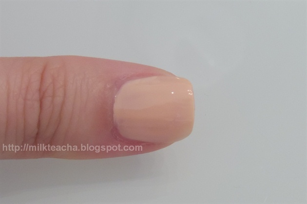 Apply nude peach polish on the thumb.