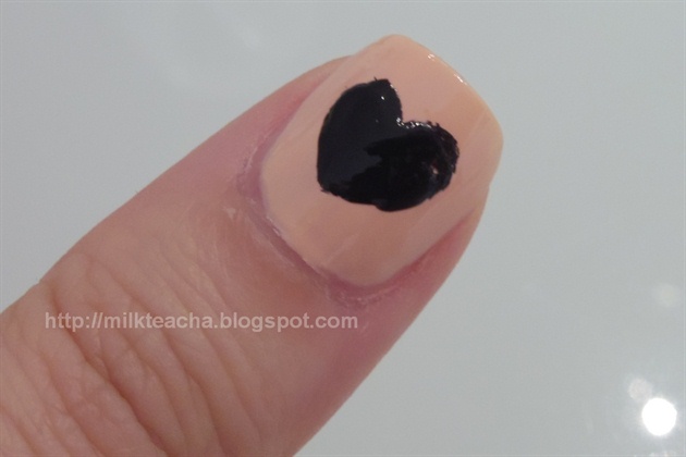 Draw a heart with black polish on the thumb.