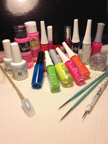 You will need base coat, top coat, white, black, neon & striper paints. brush & foil sequin dots. Apply base coat to nail.