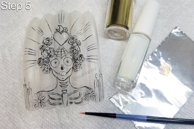 Using transfer foil glue and a small detail brush, paint glue where you would like to place metallic foil. Ensure the glue dries thoroughly before pressing the transfer foil down.