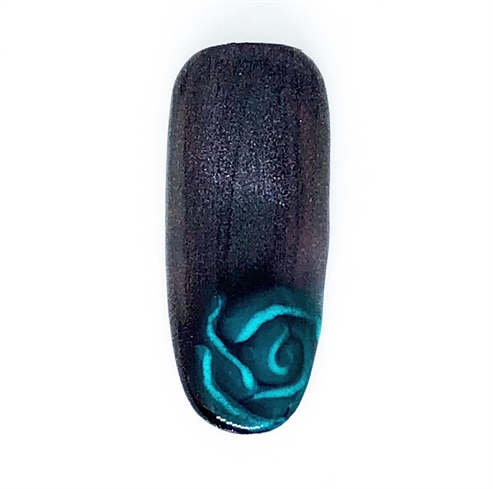 Cover the nail with one coat of Cat Eye Gel polish in Red-Blue. Using a circular magnet, hover over the rose to push the magnetic pigments away from the rose to allow for a cat eye frame.  Apply a gel top coat, cure, and cleanse the inhibition layer.