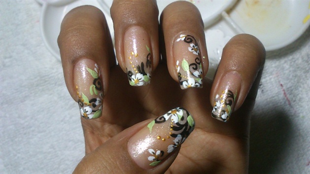 Add white flowers nd detail them with golden center nd few dots