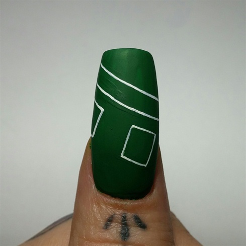 On the thumb I sculpted a long square nail. I painted the nail green and painted thin white lines to replicate a black jack table. I used green polish to clean up the white lines to make them precise.