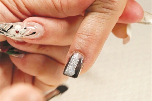 After cleaning your brush again, apply Disco Glitter Gel down the center of the nail.