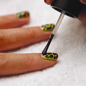 Allow the design to dry completely. Finish the look by adding a top coat to prevent smearing and to prolong wear.