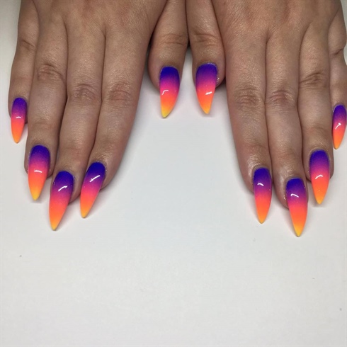 Step 1.  For the base of this nail art designs, I took some inspiration from the large Sunset strip sign, as well as the horizon of sunset strip . To achieve this look, I used  purple, pink, orange and yellow gel polishes and then blended together with a sponge.