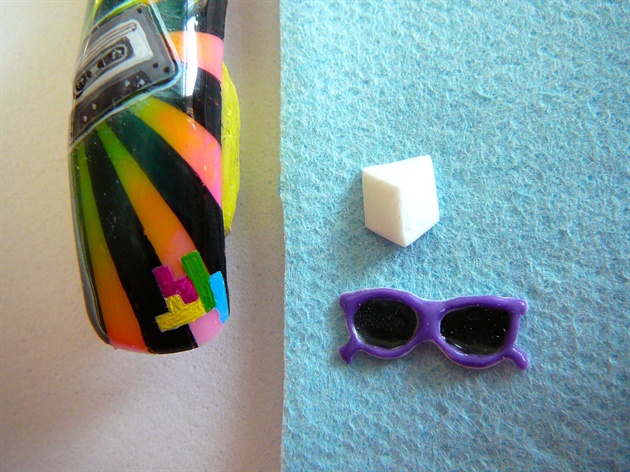 #8 ...Black gel lenses and purple frames, cure. Using acrylic paint draw a foundation for Tetris on the bottom, finish sunglasses by shaping them with an e-file, and shape the cube.