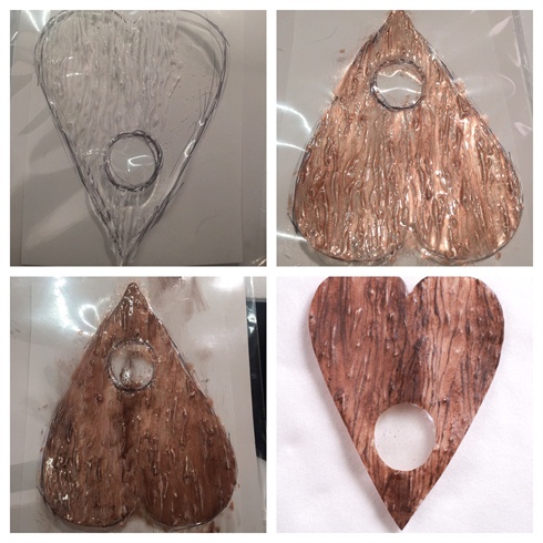 1. I started out by drawing my planchette and securing it in place with a piece of cellophane and tape. I then recreated a wood- like surface by applying gel in long lines in the structure of wood grain. (Cure)\n2. & 3 I used CND Shellac Iced Cappicino and Faux Fur for color and dimention.(cure)\n4. I filled in the Planchette hole with clear gel and finnished up with Akz'entz Matte-on.