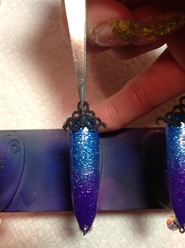 Put all 3D decorations on the nail tip with glue and clear acrylic mixture.
