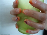 Orange nails with glitter