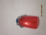 Stone on red manicure