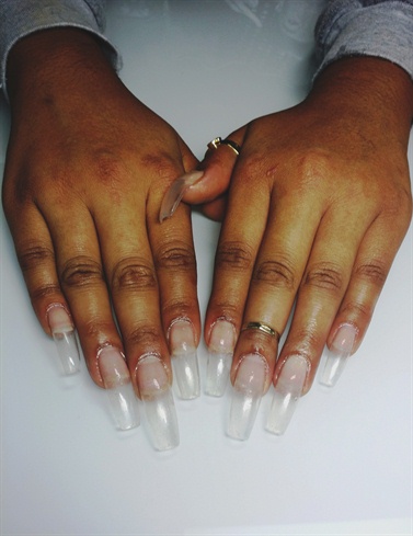 Prep the nails and apply tips with an acrylic overlay.