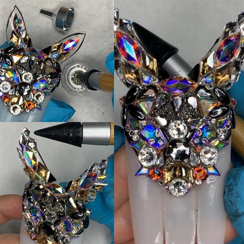 Step 3: Repeat step 2 until your entire cat head is encrusted with crystals. I used some Swarovski Crystal pixies in the rock shock collection colors to fill in some of the blank areas.