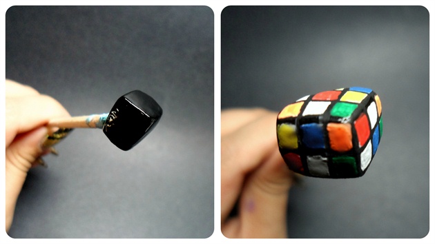 Next up, I'm sure we've all played with it at some point in our childhood! The Rubik's Cube: Make the protruding Rubik's Cube out of Acrylic, and paint on the individual blocks with acrylic paint.