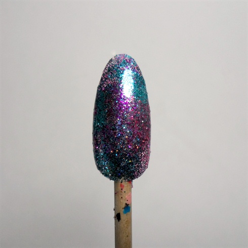 Press on a variety colors of glitters onto the nail and seal it with a clear coat.