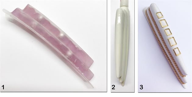 1. Using the same technique described above, create one large, layered tip. 2. Coat with White LED Gel. 3. Enhance with metal chains and embellishments.