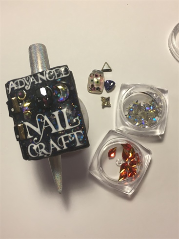 5) Finally attach the book to the nail with clear acrylic and add the final touches , Swarovski and eyeball jar with builder gel. \n