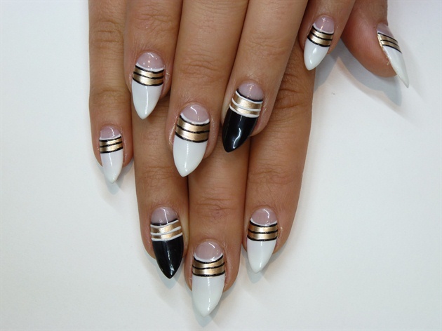 Using gel polish, paint three vey thin black lines(white for ring fingers) widthways on your gold polish.