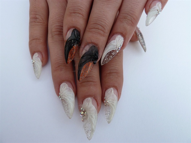 Finally, add some sparkly Swarovski crystals and some feathers to finish your angel wing nails.