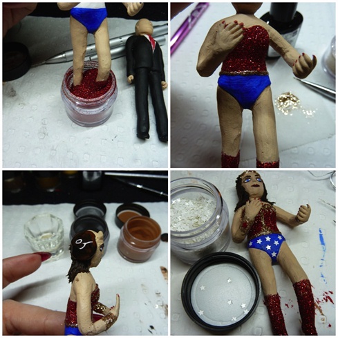 To glam up Wonder Woman, I gave her a red glitter corset and matching boots. I applied clear base gel polish and sprinkled/dipped her in glitter and cured. Her briefs were hand painted with blue acrylic paint and white glitter stars were added. For the gold detailing on her corset and her crown, I mixed clear gel polish and gold glitter. Her hair was created with black and brown acrylic and scratched using a needle pen to give a wavy finish.
