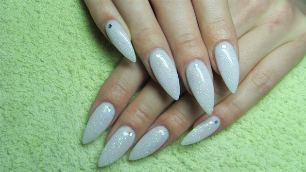 White stiletto nails with glitter